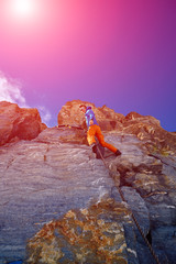 climber climbing up a cliff