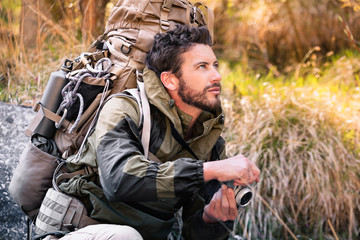 Handsome young hiker with camera