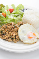 Thai spicy food basil pork with rice and fried egg on top (Krapa