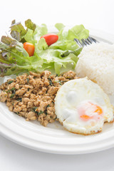 Thai spicy food basil pork with rice and fried egg on top (Krapa