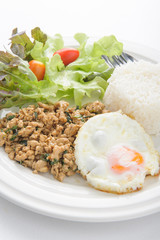 Thai spicy food basil pork with rice and fried egg on top (Krapa