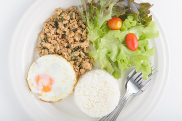 Thai spicy food basil pork with rice and fried egg on top (Krapa