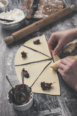 Closeup shot of gently young woman hands making a beautiful and delicious homemade rolls with...