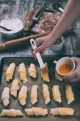 Making of beautiful and delicious homemade rolls. Photographed from above on rustic wooden table. Post processed to mach old film look and vintage colors.