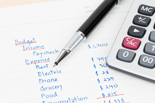 Hand Writing Home Budget With Calculator