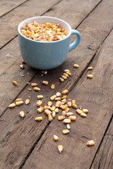 Corn grains on wooden table