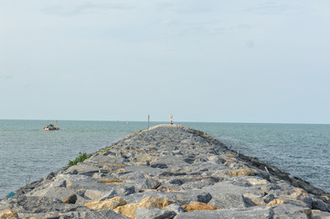 Rock dam and sea with blue sky