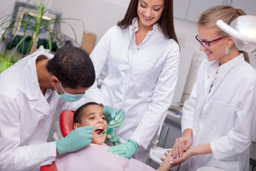 Close up of boy having his teeth examined by a dentist