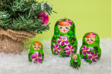 Russian wooden dolls with snow and Christmas tree