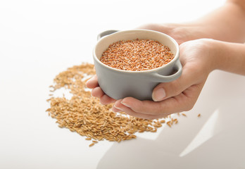 red rice hold by hand studio shot