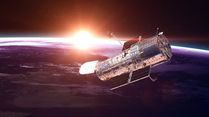 The Hubble Space Telescope in orbit above the Earth. Elements of this image furnished by NASA