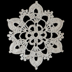 Crocheted snowflake on a black background