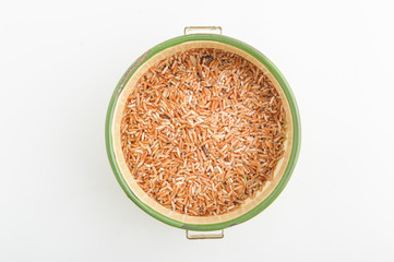 Thai organic brown rice in the bowl isolated on white background