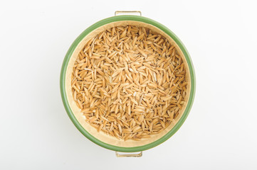 paddy rice in white plate is on white background
