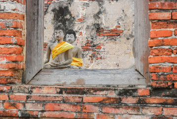 Ruin and ancient orange brick wall with a window view to the tre