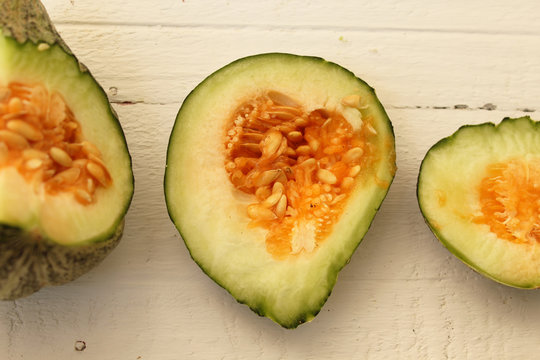 Sliced melon on a wooden background