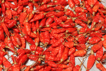 Hot dried red chillies as a textured food background.