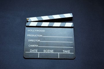 still life on a blue background of clapperboard to work on cinema and movie