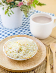 apple crumble with hot chocolate and flower background on bamboo plate