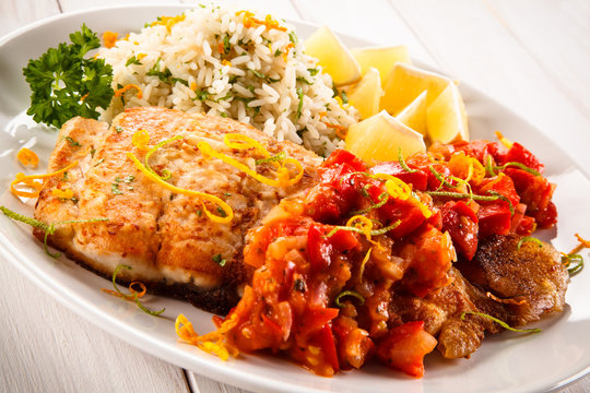 Fish dish - fried fish fillet white rice and vegetables 