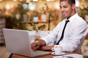 young businessman in the coffee break working on his laptop