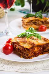 Piece of tasty hot lasagna with red wine..