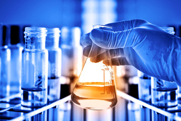 Flask in scientist hand in laboratory 
