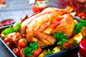 Roasted turkey garnished with potato, vegetables and cranberries. Thanksgiving or Christmas dinner