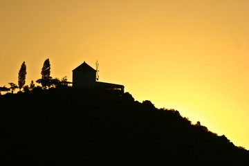 Silhouette of a wind mill in the sunset in Peloponese in greece