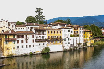 Fototapeta na wymiar facade of houses at river brenta with village Basano del Grappa