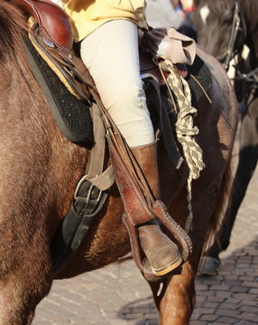 foot in the stirrup of the horse during the ride