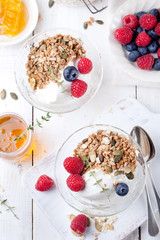 Healthy breakfast. Granola with pumpkin seeds, honey, yogurt, fresh berries .