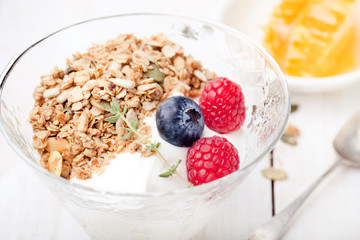 Healthy breakfast. Granola with pumpkin seeds, honey, yogurt, fresh berries .