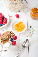 Healthy breakfast. Granola with pumpkin seeds, honey, yogurt, fresh berries .