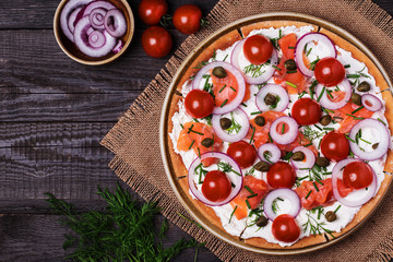 Scandinavian salmon pizza with cream cheese, capers, tomato.