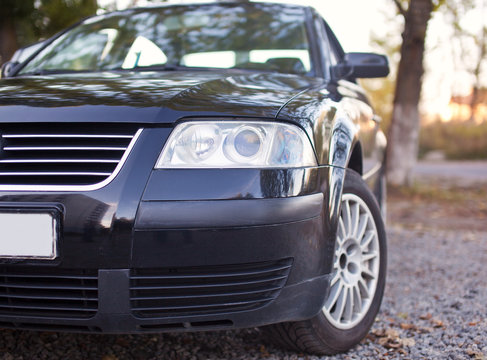 Headlights of the black car close-up photo