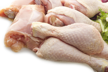 Fresh skinless chicken thighs and legs on the white