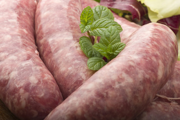 raw homemade sausage on a wooden board