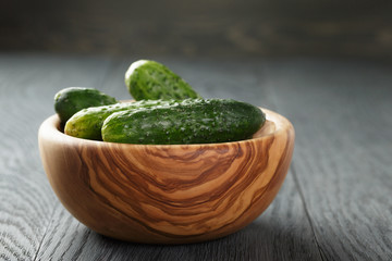 whole cucumbers in olive bowl