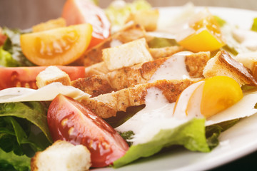 caesar salad with chiken fillet and different color tomatoes