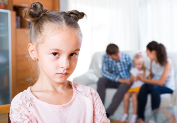 Family and jealous girl standing apart