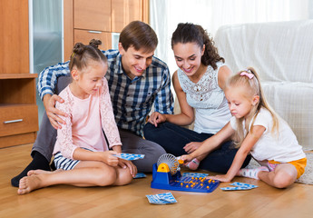 Fototapeta premium Parents and daughters with toy lotto