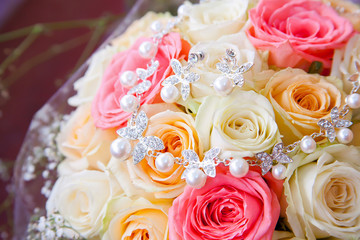 Wedding rose flowers bouquet and silver necklace with pearls