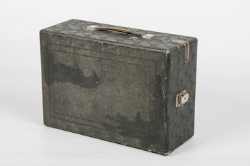 Old suitcase with gramophone standing on a white background isolated