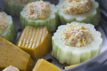 pumpkin and bitter melon stuffed with vermicelli, tofu, corn and carrot while steaming in steaming...