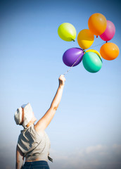 Young woman with colorful ballons on the lavander field