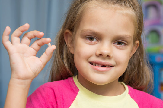 At the five year old girl fell upper front baby tooth