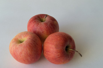Apples. On a white background three ripe red apples. Apples juicy and ripe, red and yellow.