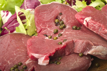 veal tenderloin with green pepper on the cutting board