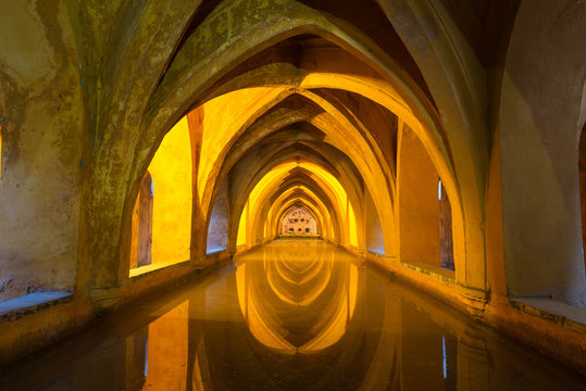 Illuminated ancient baths at the Alcazar in Seville